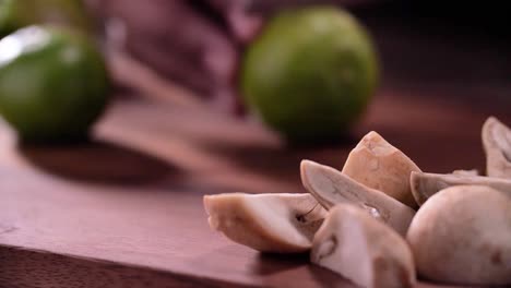 hand use knife to cut lime in half, close up, set up