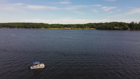 drone shot flying over a pleasure boat crossing a river in maine