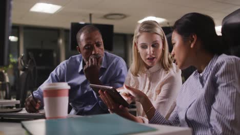 professional business people discussing over a digital tablet in modern office in slow motion