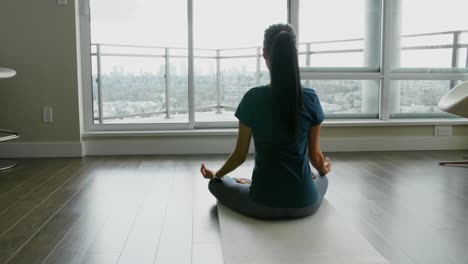 Woman-meditating-in-living-room-at-home-4k