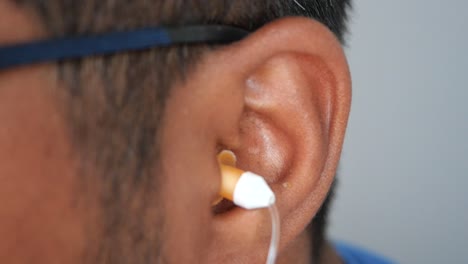 person inserting earplugs