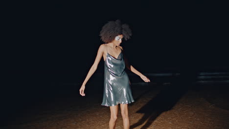 party girl dancing beach waves at night.   having fun