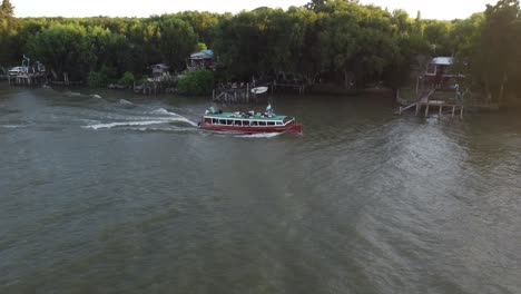 Aerial-view-of-tourist-bus-boat-cruising-on-Parana-River-in-Delta-Area-in-Argentina