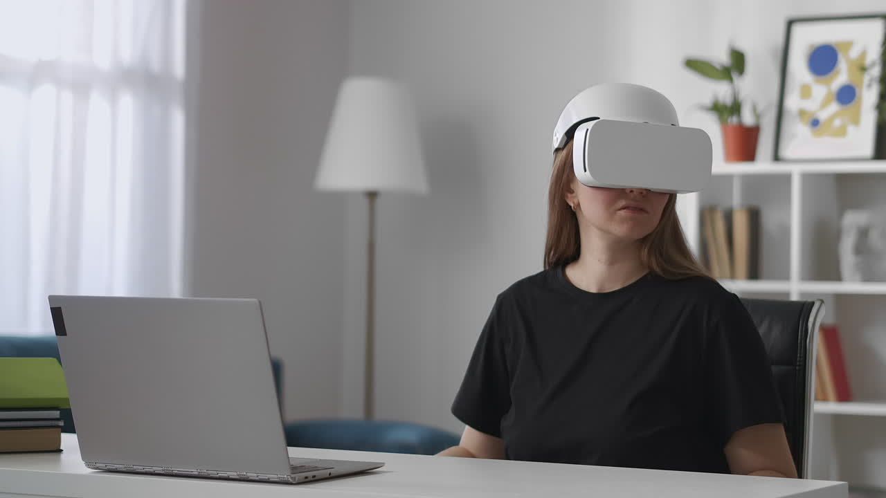 modern gadget for watching virtual reality woman is using head-mounted display in room looking around vr technology