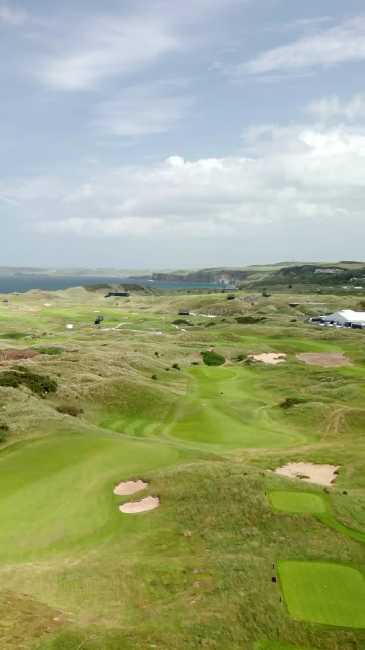 Low flying social ratio aerial video of Royal Portrush Golf Course in County Antrim, Northern Ireland, UK on a sunny day. Produced in 1080x1920 vertical ratio, 60FPS and with Rec709 color