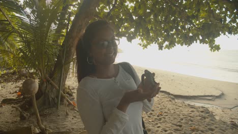 A-girl-holding-a-leatherback-hatchling-after-it-emerge-from-the-sand-and-before-making-its-way-to-the-ocean