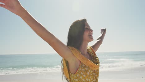 mujer caucásica disfrutando del aire fresco en la playa
