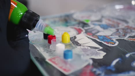 Close-up-shot-of-tattooist-green-ink-dropper-into-plastic-cap-tattoo-work-station-bench-gloves-Tattooing-Sydney-NSW-Australia-4K