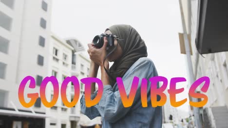 Animation-of-text-vibes-over-woman-taking-photo
