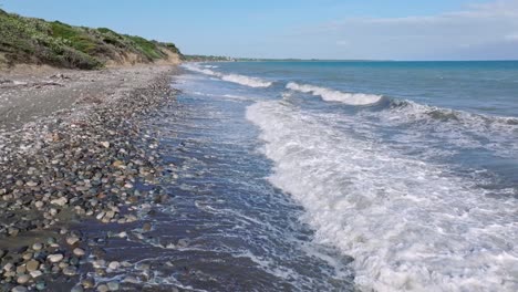 Low-flight-on-pebbled-Matanzas-Beach-in-Bani-City,-Peravia-Province,-Dominican-Republic