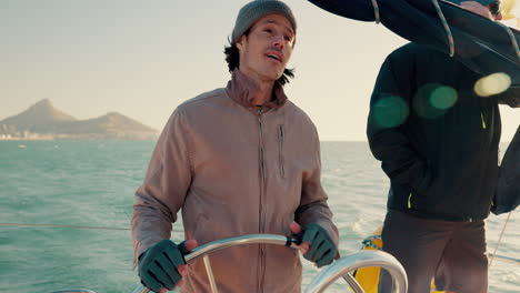 Man,-sailing-and-steering-wheel-in-boat