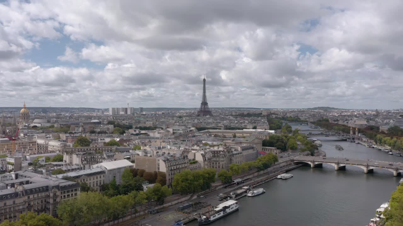 Stunning aerial drone shot captures the Eiffel Tower rising above Paris with the Seine River winding through the city’s historic skyline