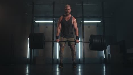 man performing a deadlift in a gym