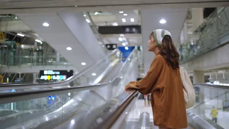 4k asian woman go to boarding gate in airport terminal.