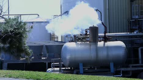 large industrial steam blowing tank procedure power plant inserted in a natural green enviroment