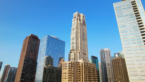 top of city highrises with bright blue sky drone