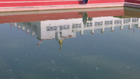 holy temple in lumbini reflected in the holy pond