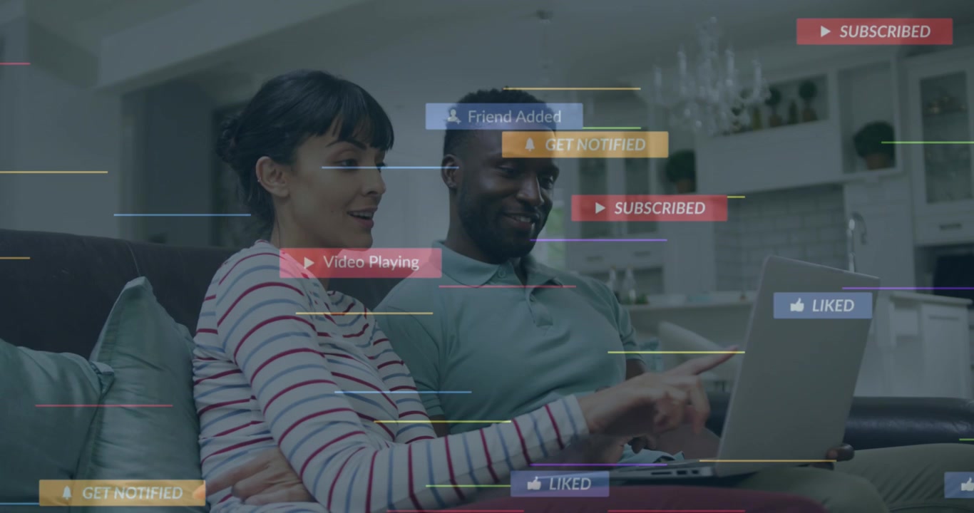 Animation of social media icons over couple smiling while using laptop together at home
