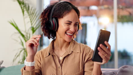 woman enjoying music with headphones and smartphone at home