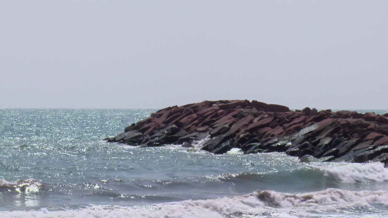 Ocean waves crashing on rocks at the shore