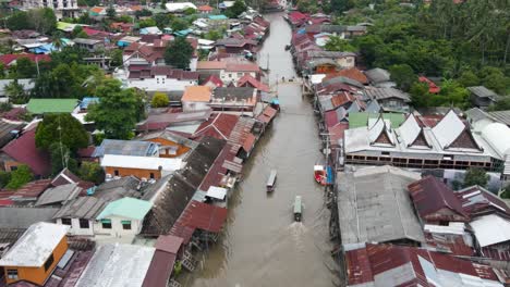 boats ride through amphawa floating market, thailand