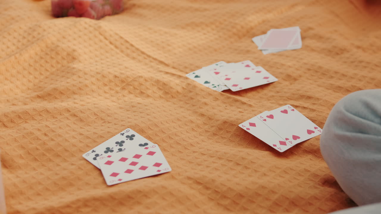 Friends Playing Cards at a Picnic