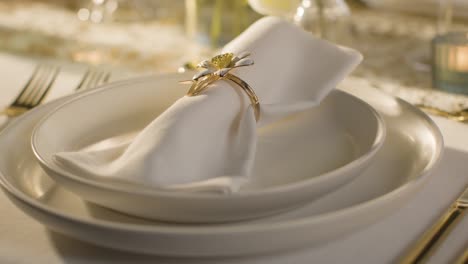 close up of napkin in ring on table set for meal at wedding reception 1