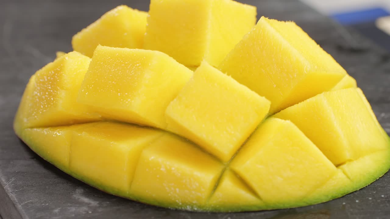 Close up rip mango slice cubes cut. High quality 4k footage