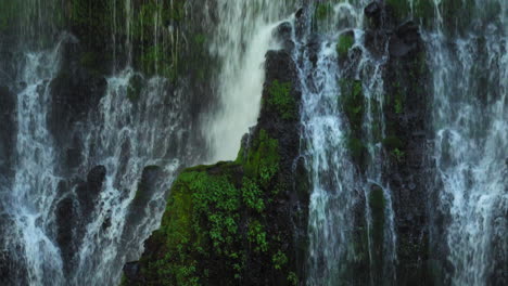 Relaxing-background-concept-of-water-falling-down-lush-cliff,-Burney-Falls,-USA