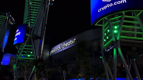 peacock theater at night with illuminated signage and urban lights