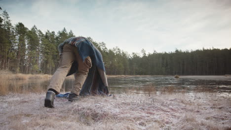 SLIDER-shot-of-an-ice-bather-warming-up-with-qigong-before-entering-the-lake