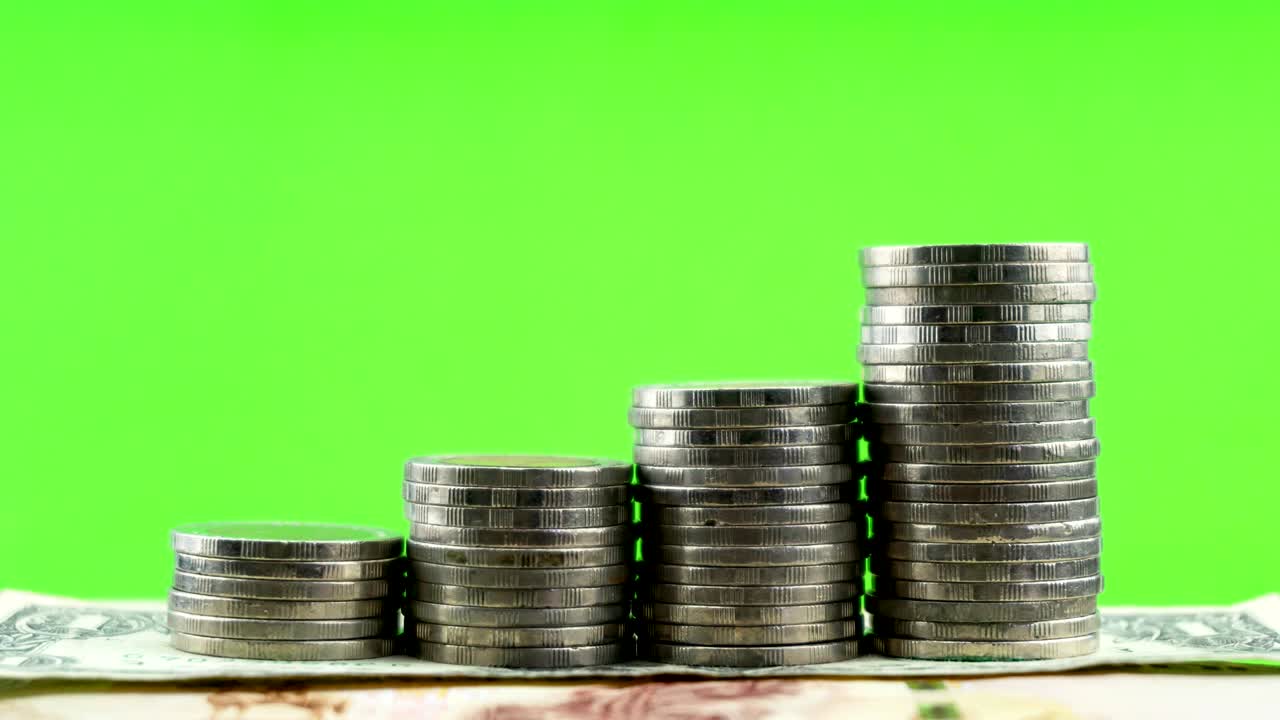 4-K Time lapse of coins on money banknote green screen paper background