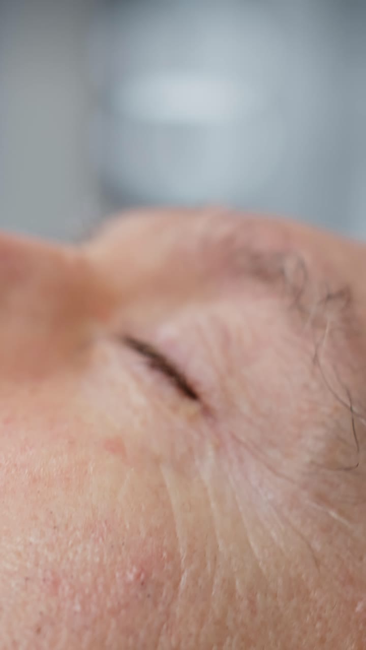 Vertical Video Doctors team in full protective gear analyzes infected patient during pandemic