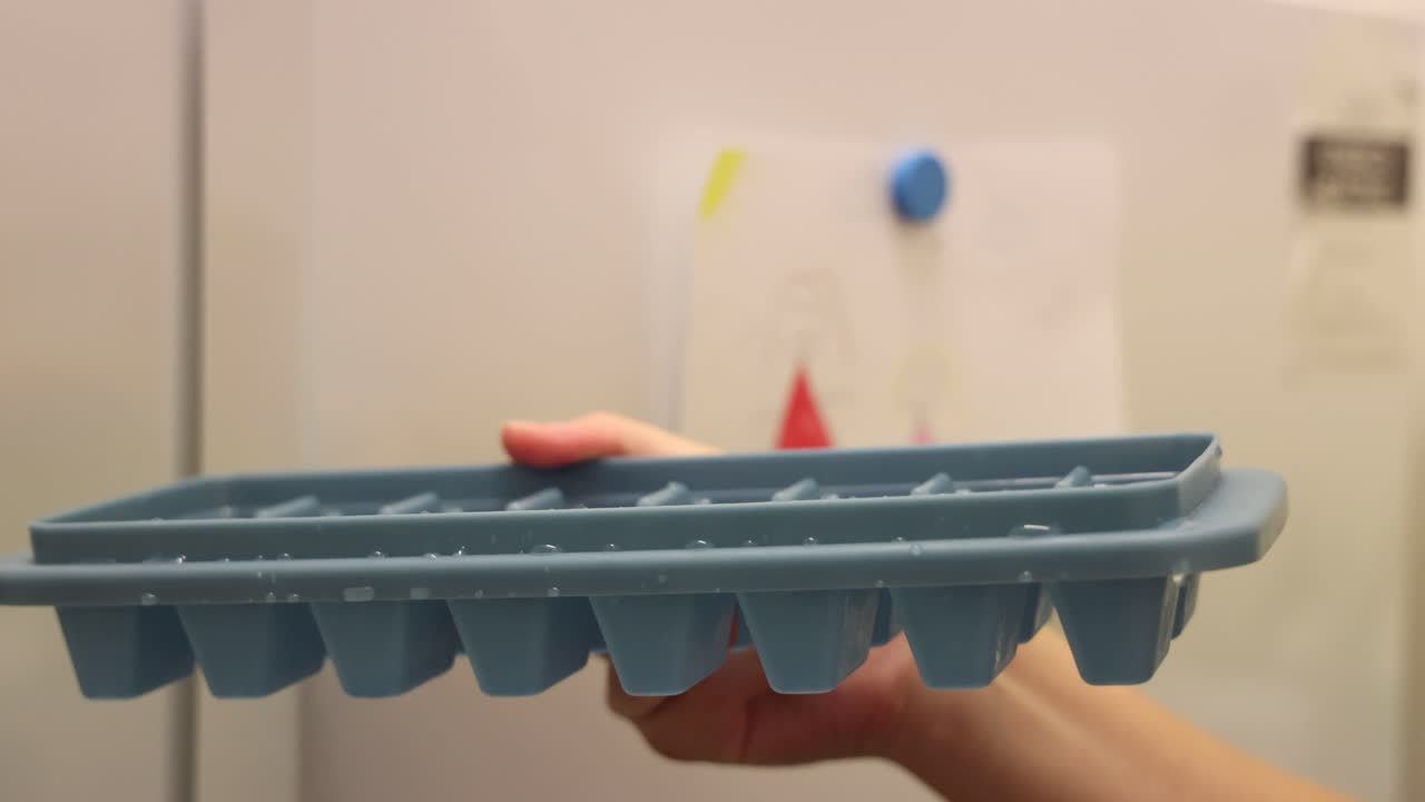 Sequence of placing an ice tray into a freezer