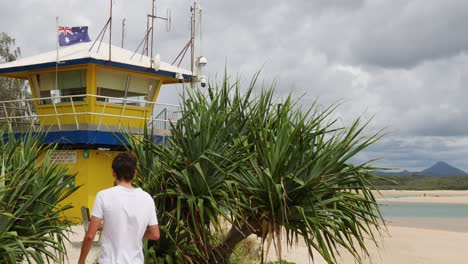 a person walks towards a colorful lifeguard station