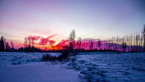 Night-to-day-timelapse-of-firey-red-sunrise-blanket-cloud-cover-over-snowy-meadow