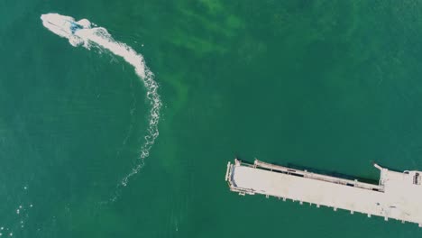 bird's-eye drone view of clear ocean reef with coal loading wharf bridge and boat in mining town catherine hill bay swansea nsw australia 3840x2160 4k