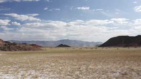 aerial drone flying low through a wide valley of the nevada desert