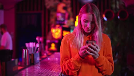 a joyful happy woman is using her phone while spending time