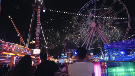 fireworks and ferris wheel at night amusement park