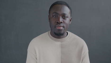 surprised man in beige sweater