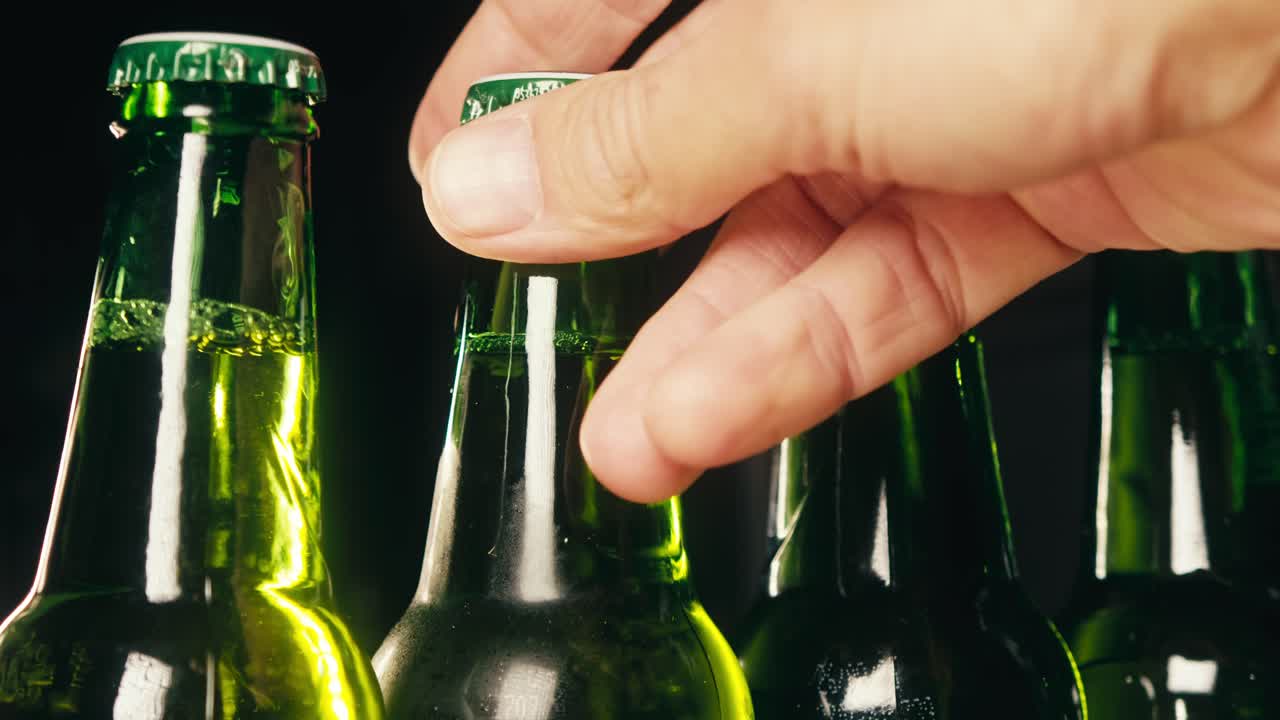 Row of beer bottles in fridge, shop or hotel, cold lager craft german beer or cider, shop supermarket or wine cooler close up.