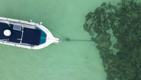 floating wooden boats with typical asian structure moored in turquoise sea