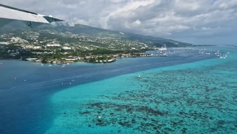 tahiti island in french polynesia. coastline view from airplane before landing on papeete international airport