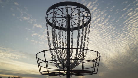 disc golf frisbee goes into disc golf basket with a "elevator" shot