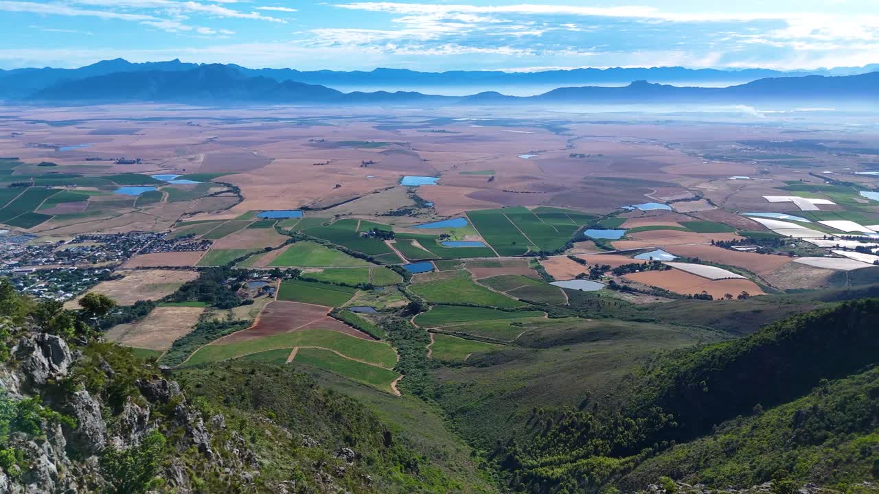 Wide-open landscapes where green vines meet towering mountains and endless blue