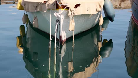 a boat's reflection in calm water