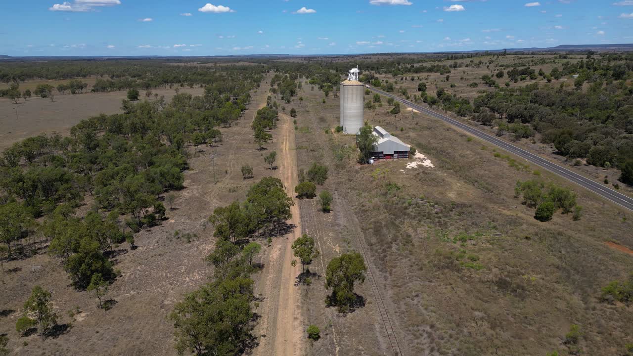 Right to left circular aerial views over grain silos just outside Wandoan, Queensland.