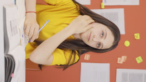 vídeo vertical de una niña que estudia infeliz.