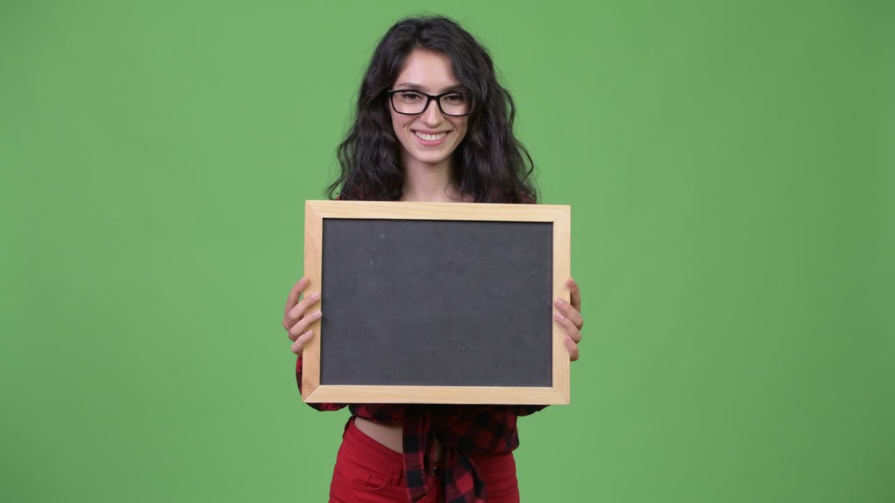 Young beautiful businesswoman holding blackboard